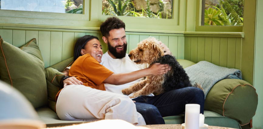 Happy Couple at home with dog