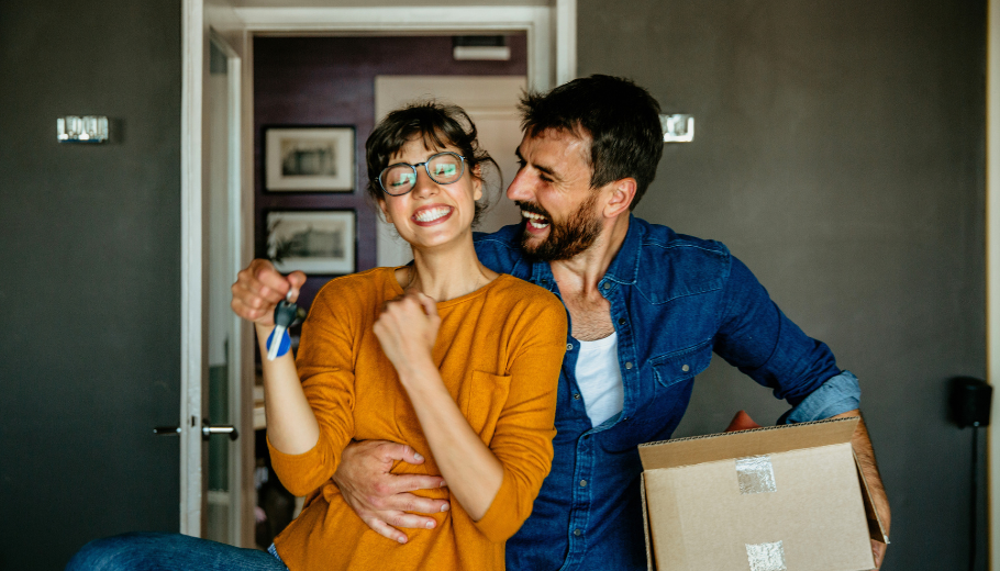 Happy couple moving into house
