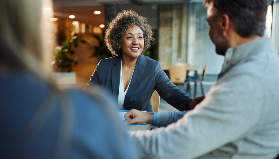 Women talking to a men and another women with paper in front of them