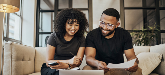 Couple sitting in front of computer