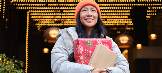 Women shopping in the winter holding gifts.